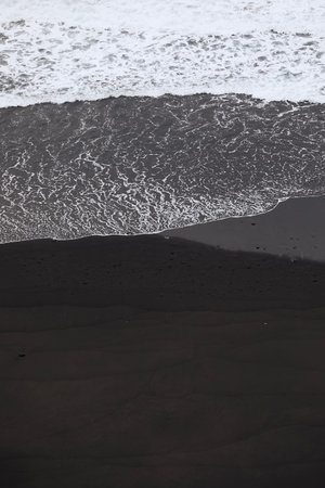 Waves on black sand beach with copy space. Beauty in nature in Tenerife. Canary Islands, Spain.