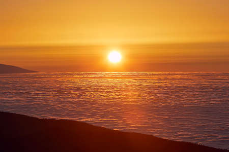 Sun above clouds. Mountain landscape at golden sunset. Tenerife, Canary Islands, Spain.の写真素材