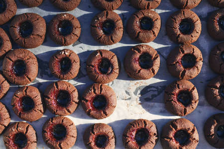 High angle view on baking tray with one missing homemade cocoa cookie.の写真素材