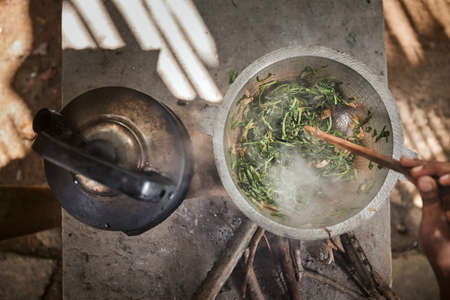 Preparing food on wood stove. Cooking in rural house in Sri Lanka.の写真素材