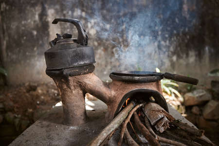 Preparing food on wood stove. Cooking in poor rural house in Sri Lanka.の写真素材