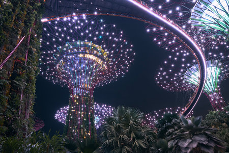 Singapore - June 26, 2022: Illuminated supertrees with skywalk during evening color light show in Gardens by the Bay in Singapore.のeditorial素材