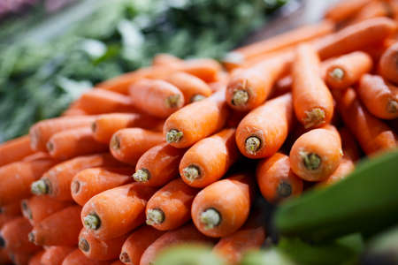 Selective focus on carrot. Sale of fresh raw vegetable in market stall.の写真素材