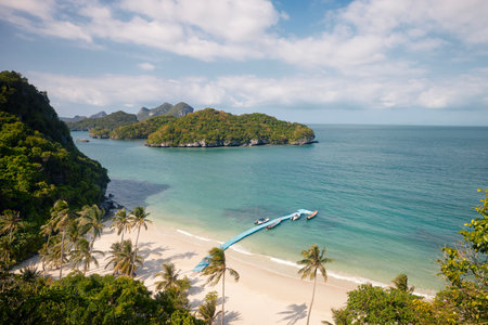 Idyllic sand beach with palm trees. Group of beautiful tropical islands in sea. Ang Thong National Marine Park near Koh Samui in Thailand.の写真素材