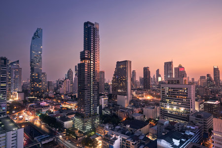 Night view of urban skyline at dusk. Downtown with skyscrapers and modern architecture. Bangkok, Thailand.の写真素材