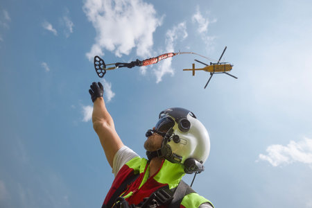 Trutnov, Czech Republic - June 22, 2023: Training in rescue in difficult to access terrain. Doctor of Helicopter Emergency Medical Service detaching himself from suspension rope under helicopter.のeditorial素材