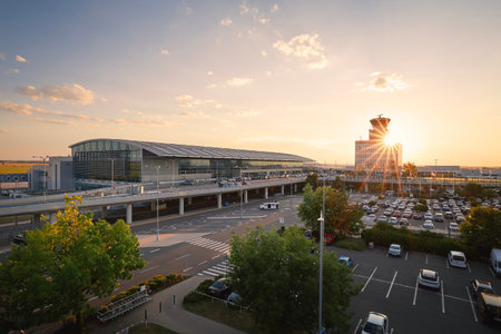 Prague, Czech Republic - July 15, 2023: Terminal building and air traffic control tower at Vaclav Havel Airport Prague at sunset.のeditorial素材