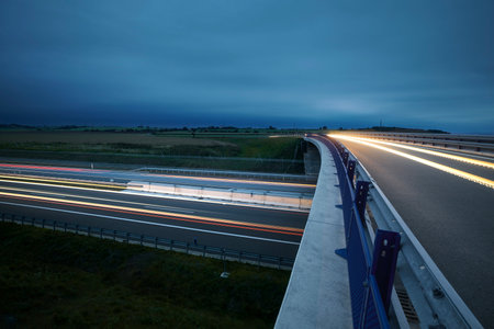 Road overpass over multiple lane highway in countryside at twilight. Themes car transportation,...