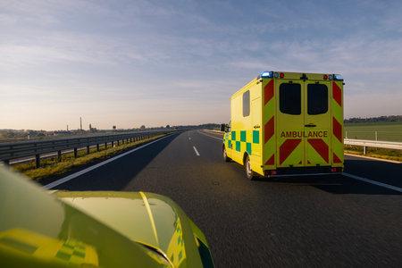 Two fast moving ambulance cars of emergency medical service on highway. Themes health care, rescue...