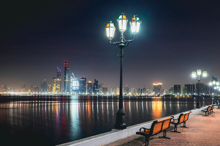 Urban skyline with skyscrapers at night. Illuminated cityscape Abu Dhabi, United Arab Emirates.の写真素材