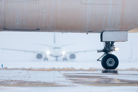 Aircraft fuselage covered with deicing fluid. Deicing of airplane before flight during winter frosty day at airport.の写真素材