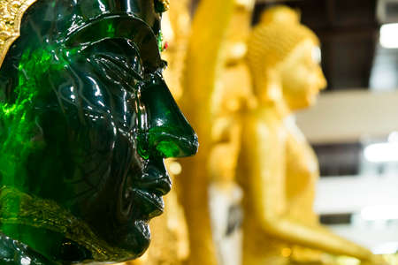 The glittering green Buddha looks respectable.の写真素材