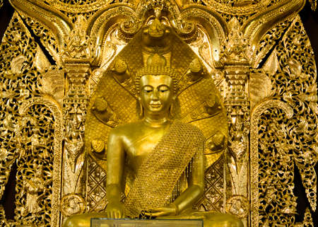 The glittering yellow Buddha looks respectable.の写真素材