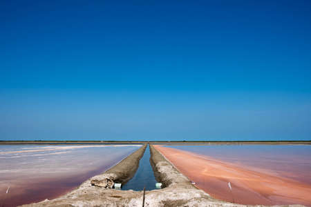 View of the vast salt fields and beautiful sky view in Thailand.の写真素材