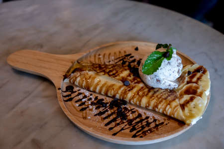 A delicious waffle ice cream served with banana for a delicious taste.の写真素材