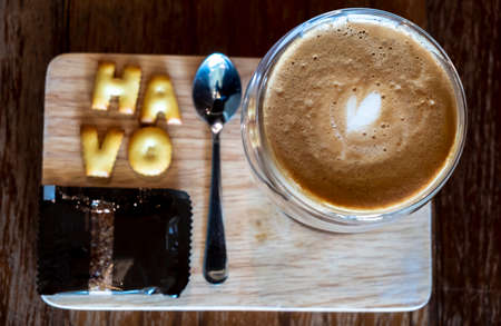 Cappuccino in a clear glass, rich color, beautifully served with crisp crackers.の写真素材