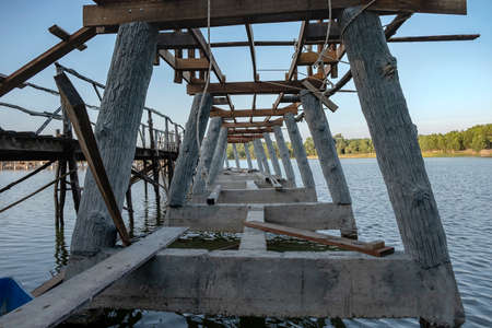 Wooden bridge is under construction. Used to walk in the lake.の写真素材