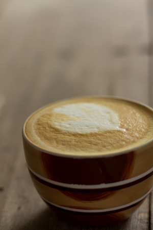 Coffee cup on the table, latte artの写真素材
