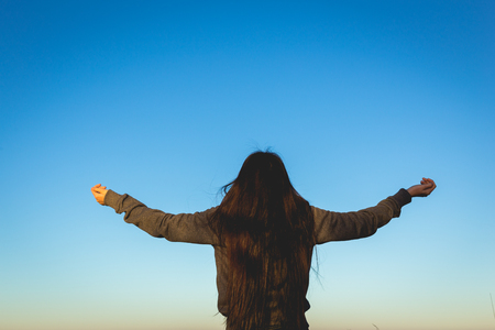 Woman expressing freedom on mountainの写真素材
