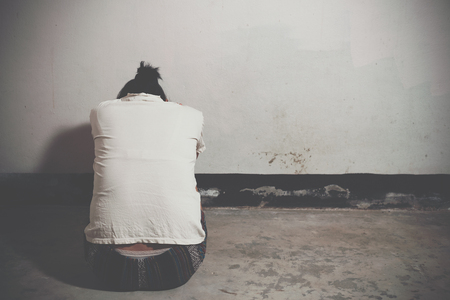 Desaturated grunge image of a very sad adult woman cryingの写真素材