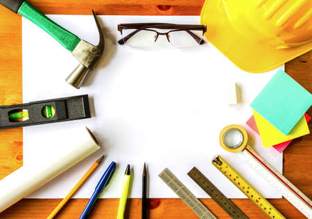 An architect working desk with tools and safety helmet with copy spaceの写真素材