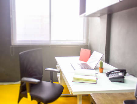Workplace with notebook laptop work table in office windows
