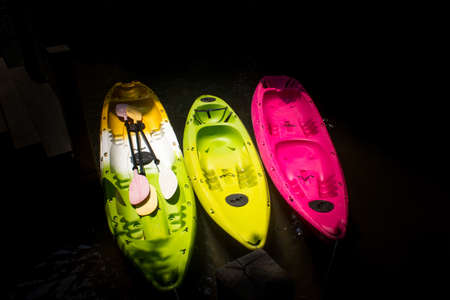 Three kayaking on the Lake.black background