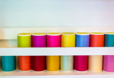 Colorful thread spools used in fabric and textile industry with copy spaceの写真素材