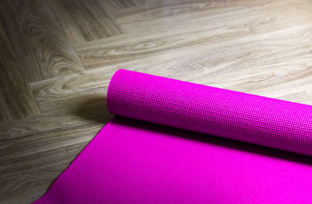 Purple Yoga Mat on a wooden background,Copy spaceの写真素材