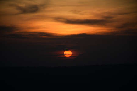 The sun went down on the edge of the mountainの写真素材