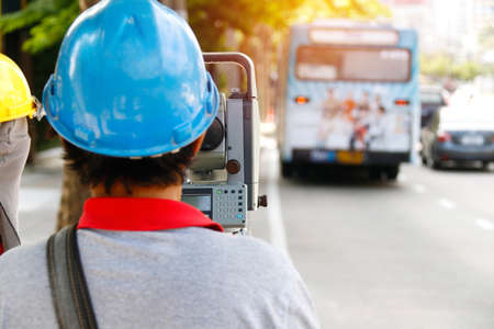 Surveyor : Surveyors use the work area monitoring tool : Surveyor with assistant to inspect work...