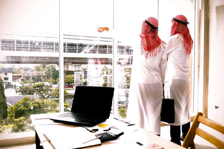 Arab business executives : Two Arab business partners are standing in the business of building a business office.の写真素材