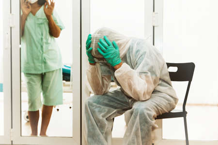 Situation of epidemics and stress between doctors who care for female patients are confined to the infected room.Coronavirus, Patients Treated to Covid-19 Epidemic in Hospitalの写真素材