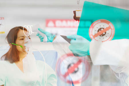 Blurred image medical team used a thermometer. Infrared fever measures and closely records symptoms...