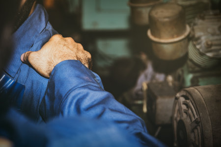 Mechanic working in a factory is frustrated with his hard work : Male colleague grabs shoulder because good hope encourages co-workers to fight.の写真素材