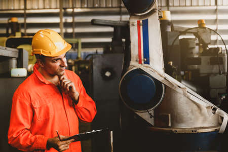 Technicians wear safety uniforms, industrial work, mechanical inspections in warehouses, check availability, safety and record as required information.の写真素材