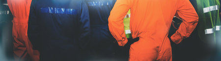 Rear view group of industrial technicians wear safety work clothes to be effective :  Meeting was delegated according to the duties of the mechanic in the industrial engineering department.の写真素材