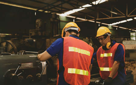 Teamwork concept : Collective teamwork of professional metal mill technicians works the machines efficiently to keep employees safe, healthy and good work quality.の写真素材