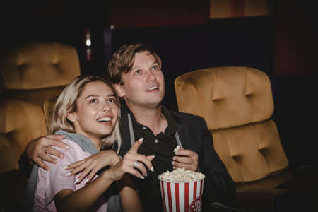 Couples, romantic at the cinema : Young people are thrilled with the thrill of watching movies in the cinema with happiness.の写真素材