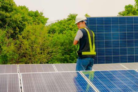 Engineer moves the solar panel to install it into the installation structure to save electricity in the factory : Safe and careful manual labor and movementの写真素材
