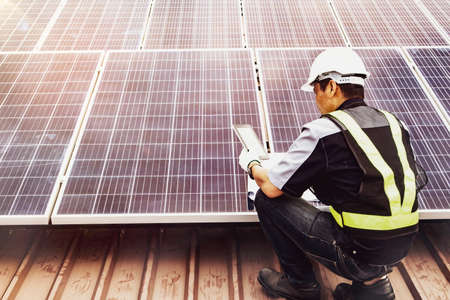 Electrical engineers inspect electronic circuits and solar panels during installation.Professionalism works outdoorsの写真素材