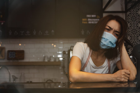 The stress of doing a coffee shop business : Business women worry about earnings and financial problemの写真素材