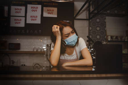 Stress of doing a coffee shop business : Business women suffer from debt, income worries and financial stress as the coronavirus epidemic has led to losses and financial liquidity in their businessesの写真素材