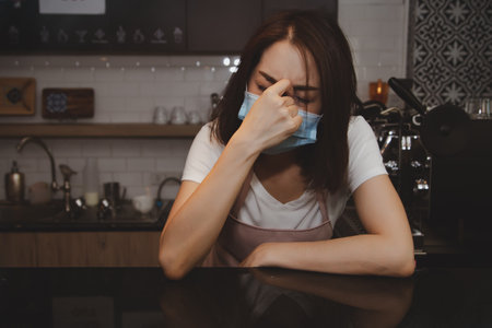 adapting, asian, barista, bored, business, businesswoman, cafe, caucasian, coffee shop, contagion, coronavirus, covid -19, disappointment, disease, disgraceful, disheartened, dismal, emotion, evening,の写真素材