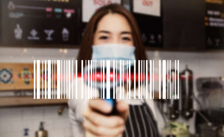 Close up Barcode scans from young Asian businessmen working in coffee shops showcasing state-of-the-art barcode scanners : Blurred backgroundの写真素材