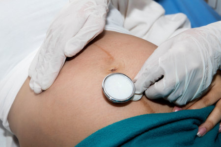 Closeup of the hands, the doctor uses a medical headset to hear the fetus and develop the baby's movement within the mother's stomach before birth.の写真素材