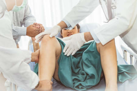 Blurred photo medical team takes care of pregnant women with care and analysis, aching muscles in the legs and allowing patients to relieve anxiety : Blurred backgroundの写真素材
