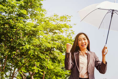 World environment day concept : Asian business women enjoy the environment, green trees and clean...