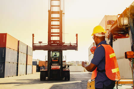 Teamwork, control workers work on cranes, loading intermediate container boxes, ordering trucks,...