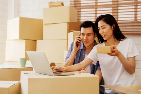 Work From Home online : Couple doing SME businesses deliver products online to customers who order products via the Internet, helping to sell happily : Selective Focusの写真素材
